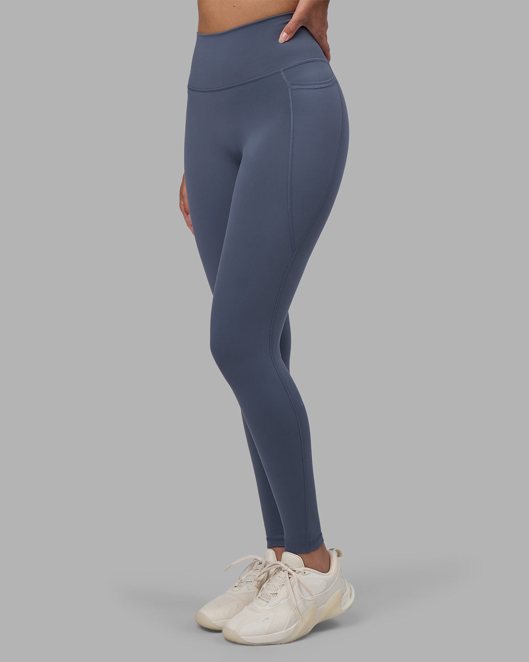 Woman wearing Fusion Ultra High-Rise Full Length Legging Pockets - Night Shadow | Model:Rhiley | Size:S - view 1