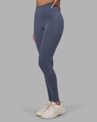 Woman wearing Fusion Ultra High-Rise Full Length Legging Pockets - Night Shadow | Model:Rhiley | Size:S | Thumbnail Index: 0