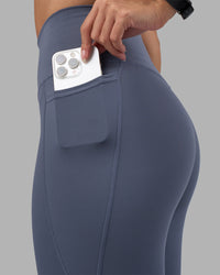 Woman wearing Fusion Ultra High-Rise Full Length Legging Pockets - Night Shadow | Model:Rhiley | Size:S | Thumbnail Index: 2