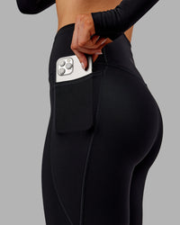 Woman wearing Fusion Ultra High-Rise Full Length Thermal Legging Pockets - Black | Model:Ella | Size:S | Thumbnail Index: 2