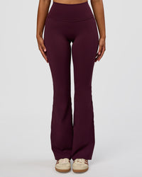 Woman wearing Fusion V-Contour High-Rise Flared Legging Pockets - Cherry Lacquer | Model:Jordan | Size:S | Thumbnail Index: 0