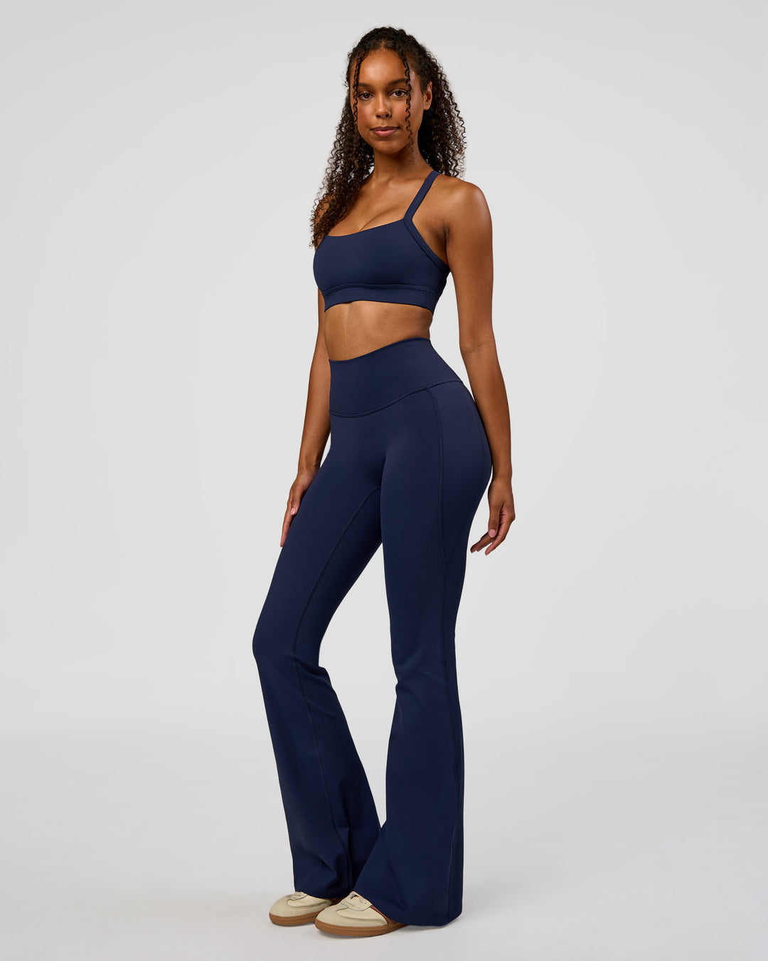 Woman wearing Fusion V-Contour High-Rise Flared Legging Pockets - Future Navy | Model:Jordan | Size:S - view 11