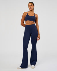 Woman wearing Fusion V-Contour High-Rise Flared Tall Legging Pockets - Future Navy | Model:Rosie | Size:S | Thumbnail Index: 3