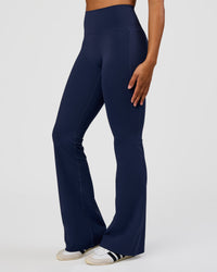 Woman wearing Fusion V-Contour High-Rise Flared Tall Legging Pockets - Future Navy | Model:Rosie | Size:S | Thumbnail Index: 2