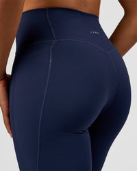 Woman wearing Fusion V-Contour High-Rise Flared Tall Legging Pockets - Future Navy | Model:Rosie | Size:S | Thumbnail Index: 7
