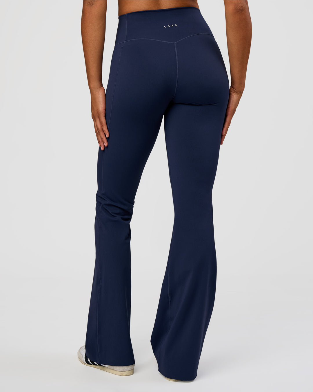 Woman wearing Fusion V-Contour High-Rise Flared Tall Legging Pockets - Future Navy | Model:Rosie | Size:S - view 1