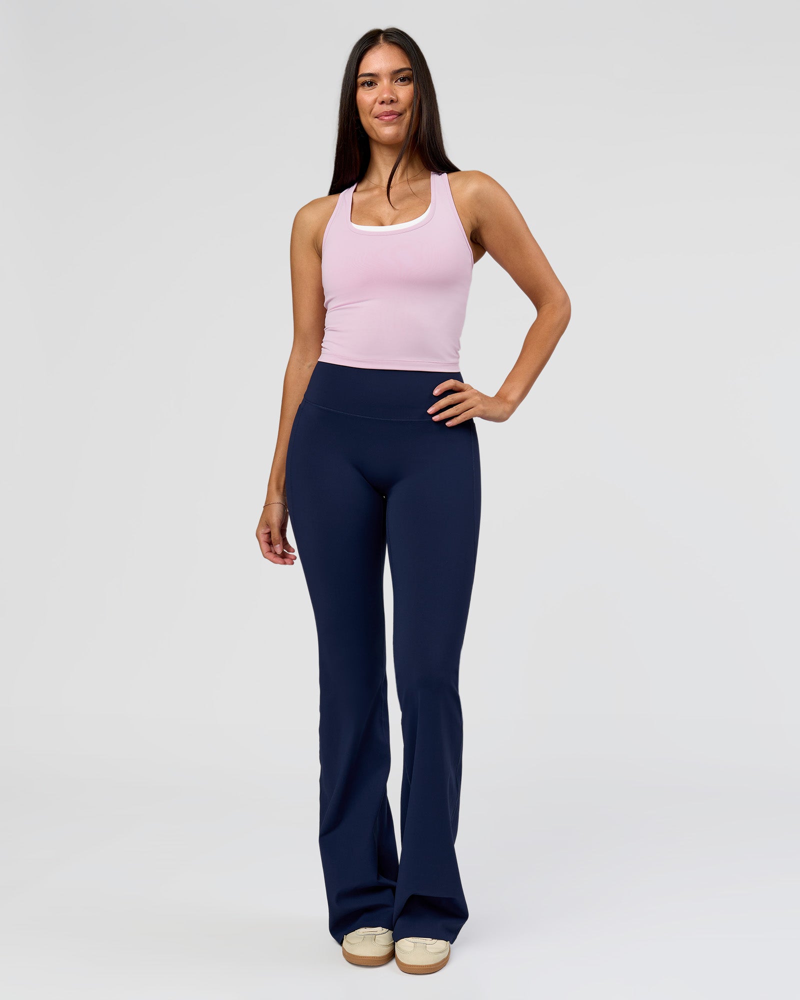 Woman wearing Fusion V-Contour High-Rise Flared Tall Legging Pockets - Future Navy | Model:Rosie | Size:S