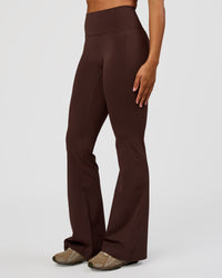Woman wearing Fusion V-Contour High-Rise Flared Tall Legging Pockets - Hot Chocolate | Model:Rosie | Size:S | Thumbnail Index: 0