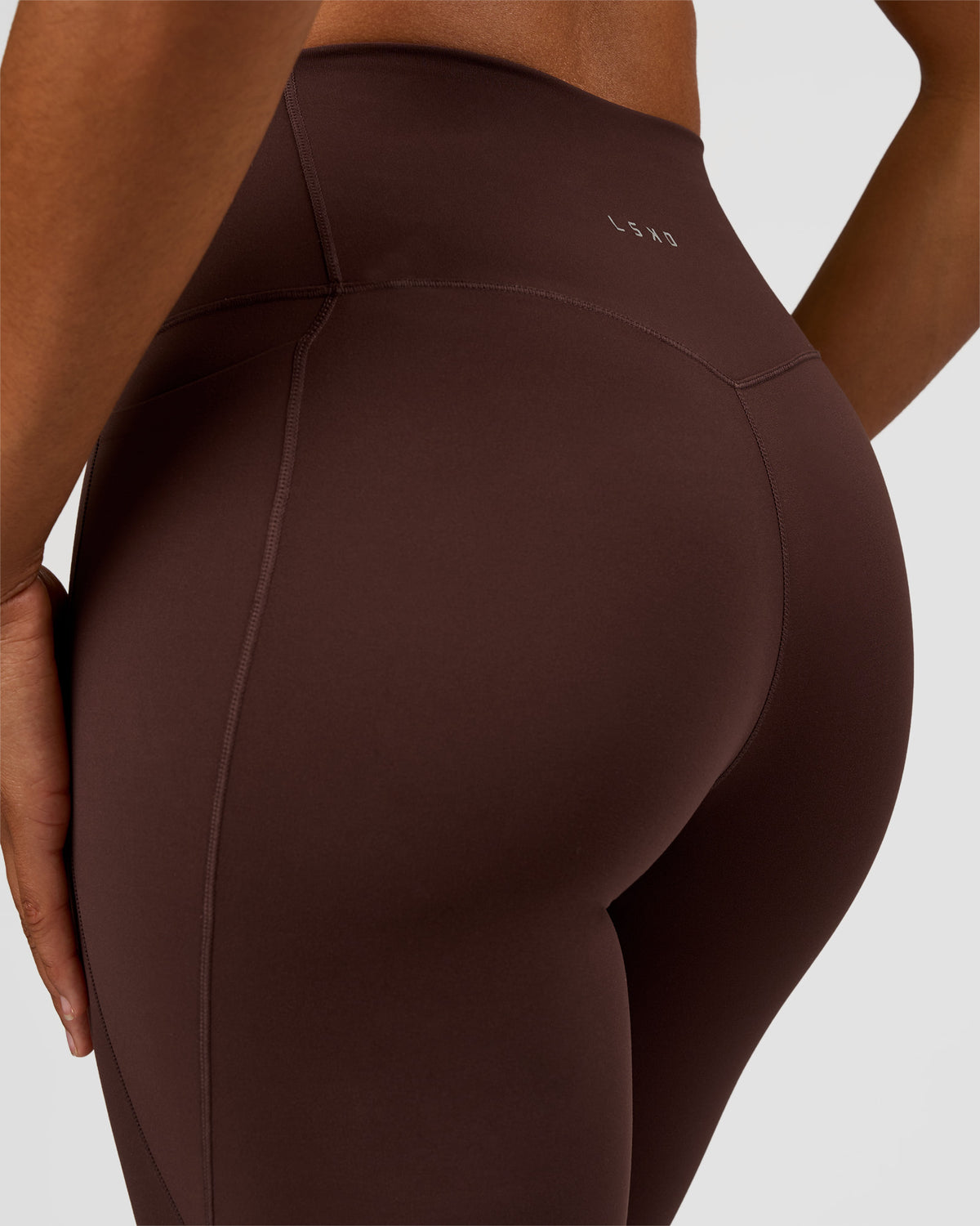 Woman wearing Fusion V-Contour High-Rise Flared Tall Legging Pockets - Hot Chocolate | Model:Rosie | Size:S