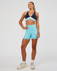 Woman wearing Fusion V-Contour Ultra High-Rise 4” Short Pockets - Baltic Sea | Model:Emelia | Size:S | Thumbnail Index: 6