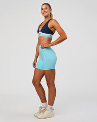 Woman wearing Fusion V-Contour Ultra High-Rise 6" Short Pockets - Baltic Sea | Model:Emelia | Size:S | Thumbnail Index: 5