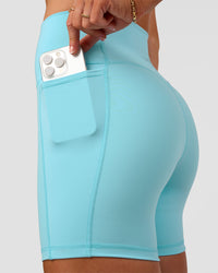 Woman wearing Fusion V-Contour Ultra High-Rise 6" Short Pockets - Baltic Sea | Model:Emelia | Size:S | Thumbnail Index: 4