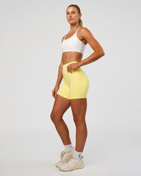 Woman wearing Fusion V-Contour Ultra High-Rise 6" Short Pockets - Yellow Fizz | Model:Emelia | Size:S | Thumbnail Index: 5