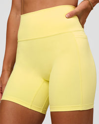 Woman wearing Fusion V-Contour Ultra High-Rise 6" Short Pockets - Yellow Fizz | Model:Emelia | Size:S | Thumbnail Index: 7