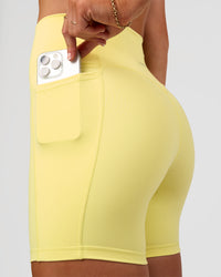 Woman wearing Fusion V-Contour Ultra High-Rise 6" Short Pockets - Yellow Fizz | Model:Emelia | Size:S | Thumbnail Index: 4
