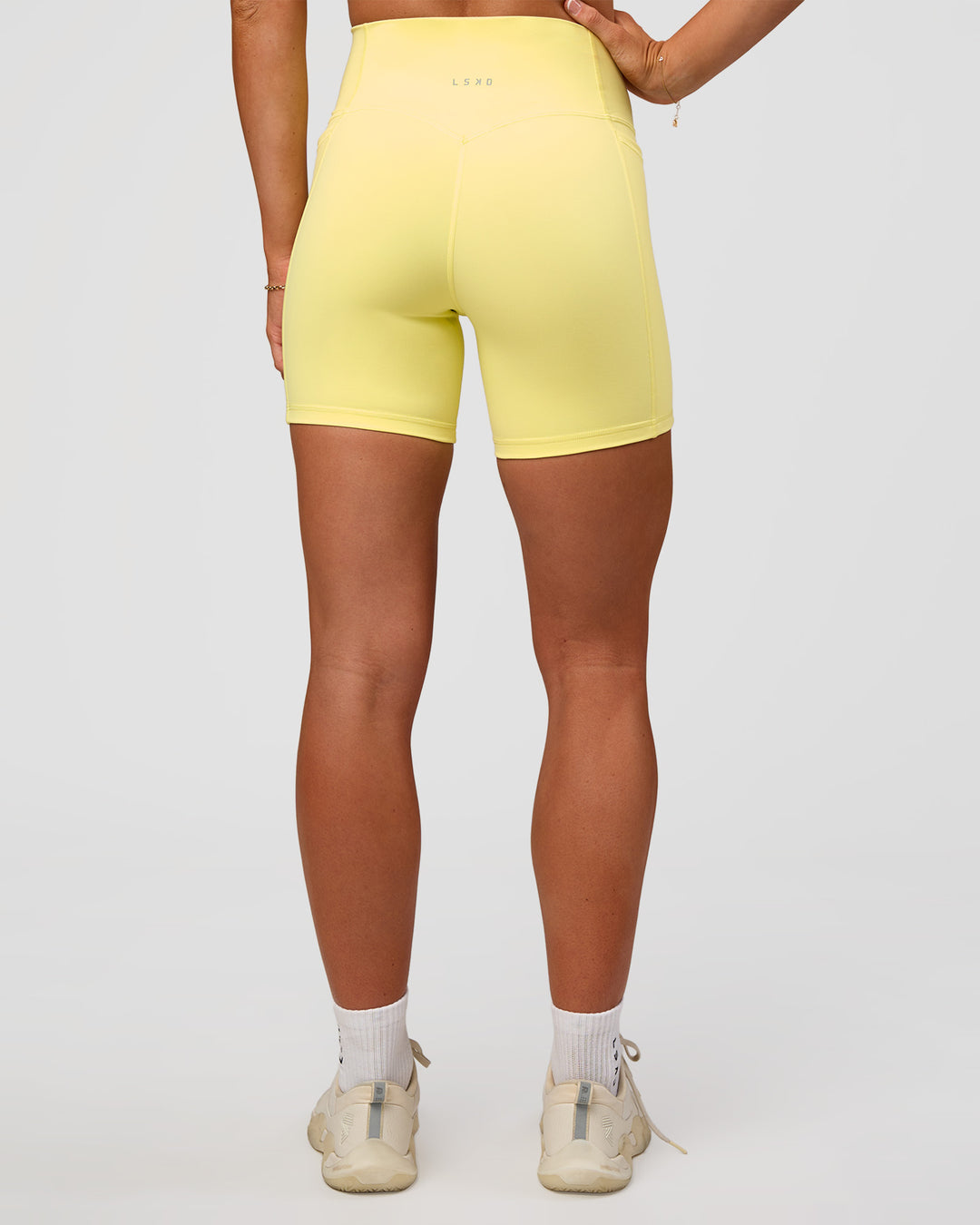 Woman wearing Fusion V-Contour Ultra High-Rise 6" Short Pockets - Yellow Fizz | Model:Emelia | Size:S - view 4