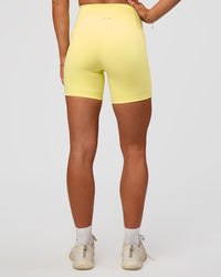 Woman wearing Fusion V-Contour Ultra High-Rise 6" Short Pockets - Yellow Fizz | Model:Emelia | Size:S | Thumbnail Index: 3