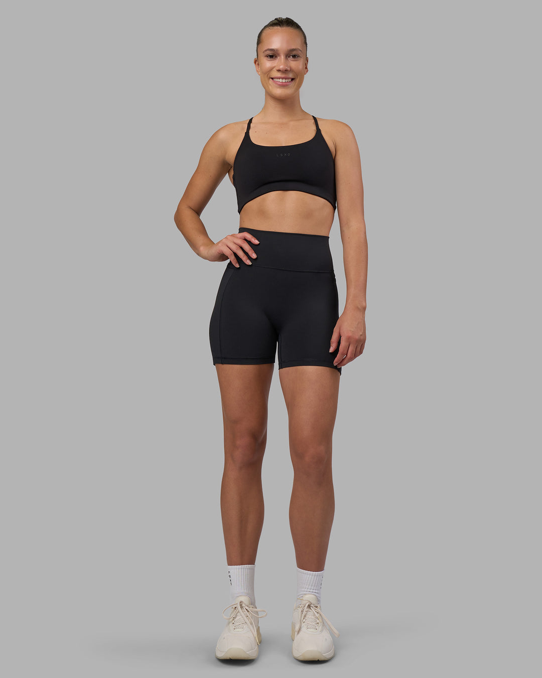 Woman wearing Fusion V-Contour Ultra High-Rise 4” Short Pockets - Black | Model:Charlize | Size:S - view 5