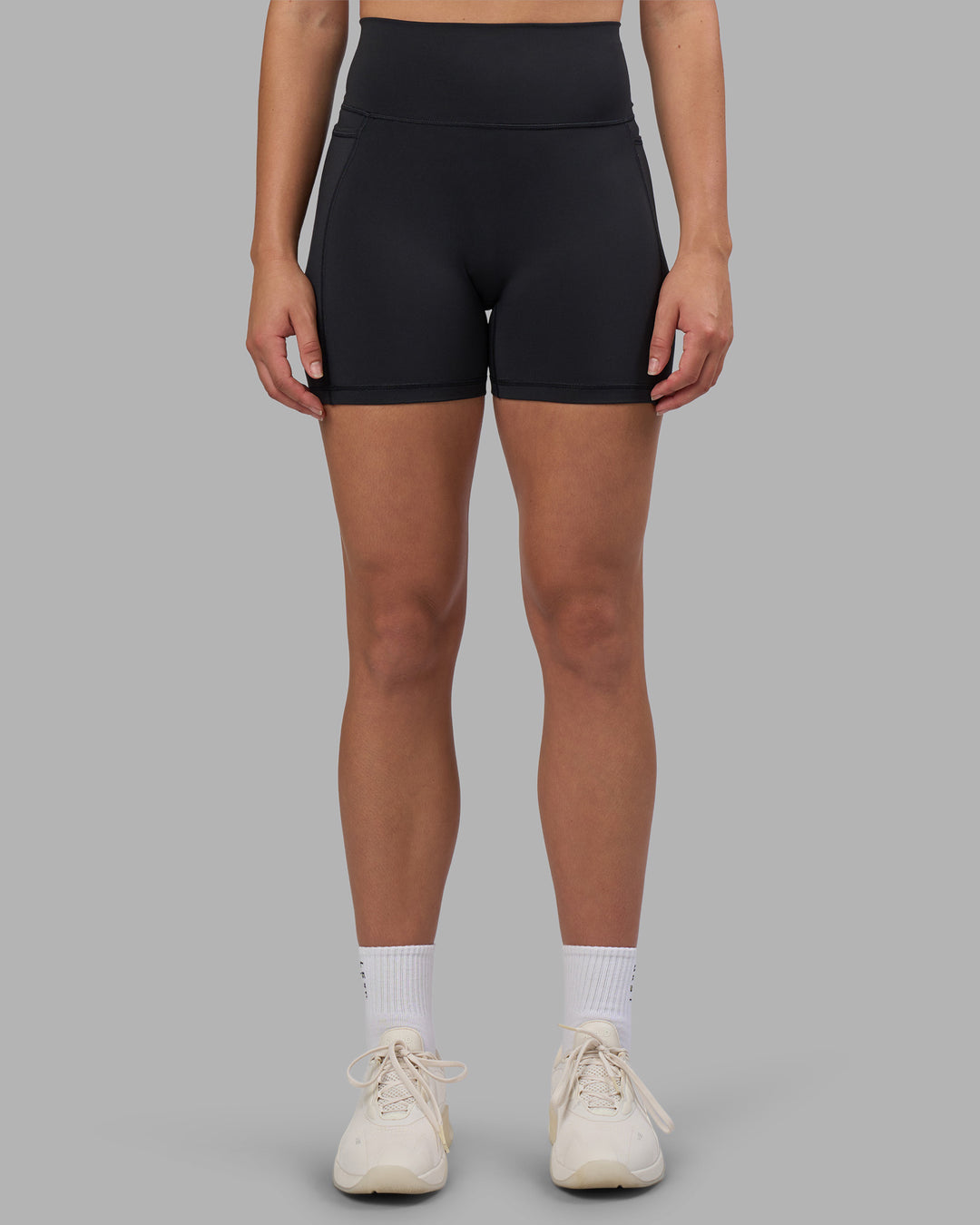 Woman wearing Fusion V-Contour Ultra High-Rise 4” Short Pockets - Black | Model:Charlize | Size:S - view 2