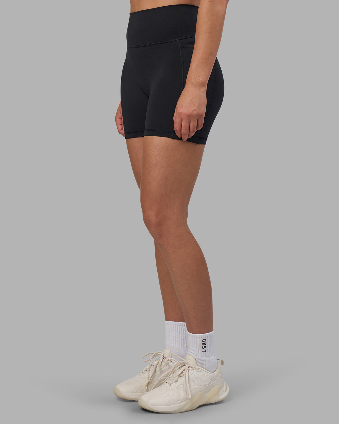 Woman wearing Fusion V-Contour Ultra High-Rise 4” Short Pockets - Black | Model:Charlize | Size:S - view 9