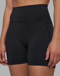 Woman wearing Fusion V-Contour Ultra High-Rise 4” Short Pockets - Black | Model:Charlize | Size:S | Thumbnail Index: 6