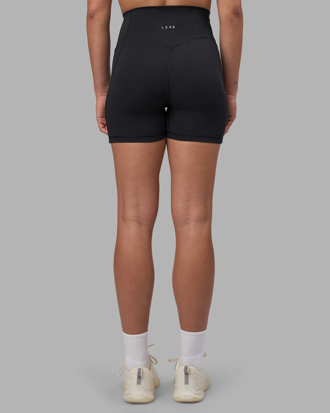 Woman wearing Fusion V-Contour Ultra High-Rise 4” Short Pockets - Black | Model:Charlize | Size:S - view 8