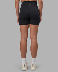 Woman wearing Fusion V-Contour Ultra High-Rise 4” Short Pockets - Black | Model:Charlize | Size:S | Thumbnail Index: 7