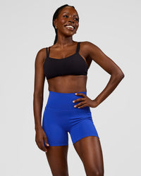Woman wearing Fusion V-Contour Ultra High-Rise 4” Short Pockets - Electric Indigo | Model:Ellie | Size:S | Thumbnail Index: 2