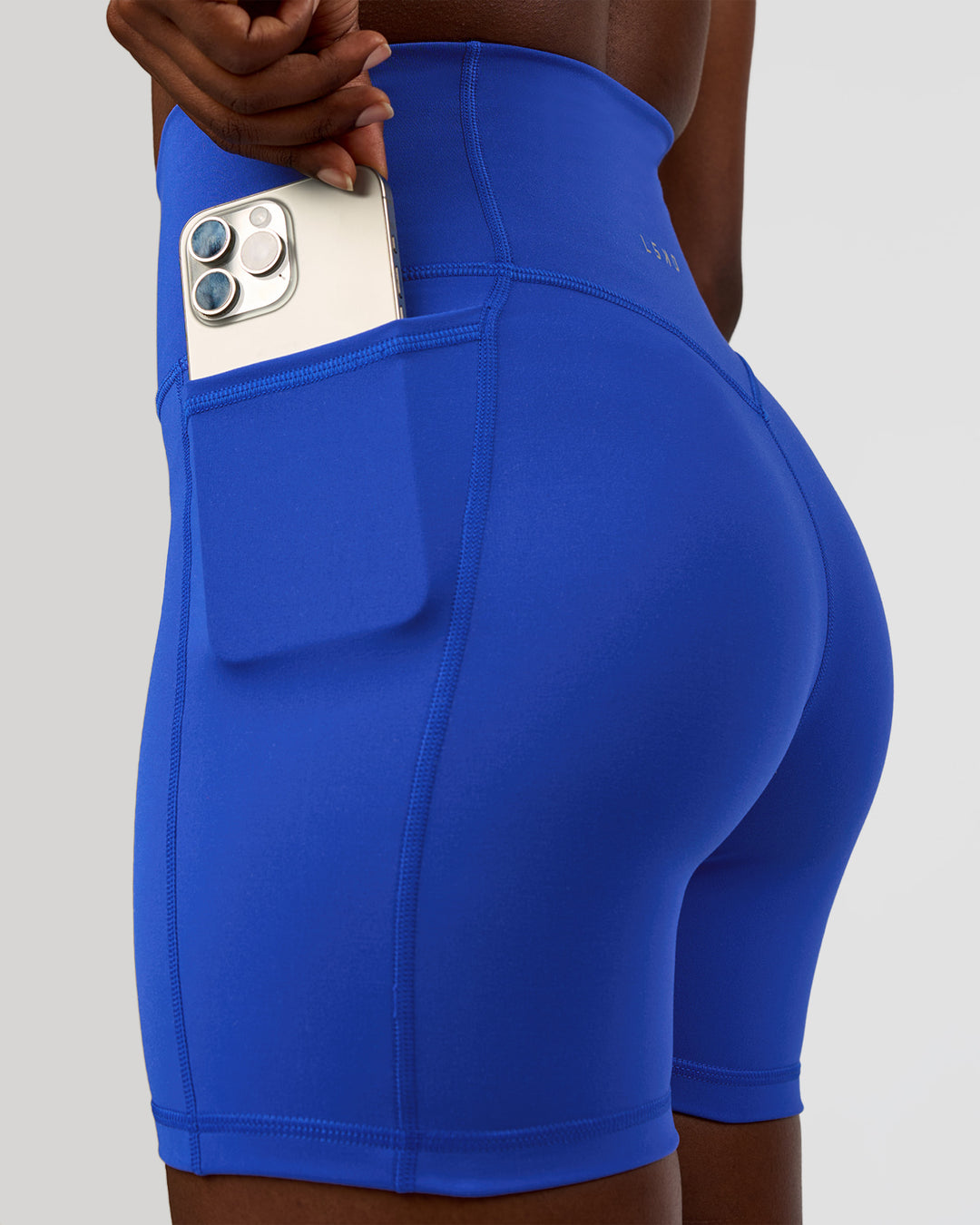 Woman wearing Fusion V-Contour Ultra High-Rise 4” Short Pockets - Electric Indigo | Model:Ellie | Size:S - view 2