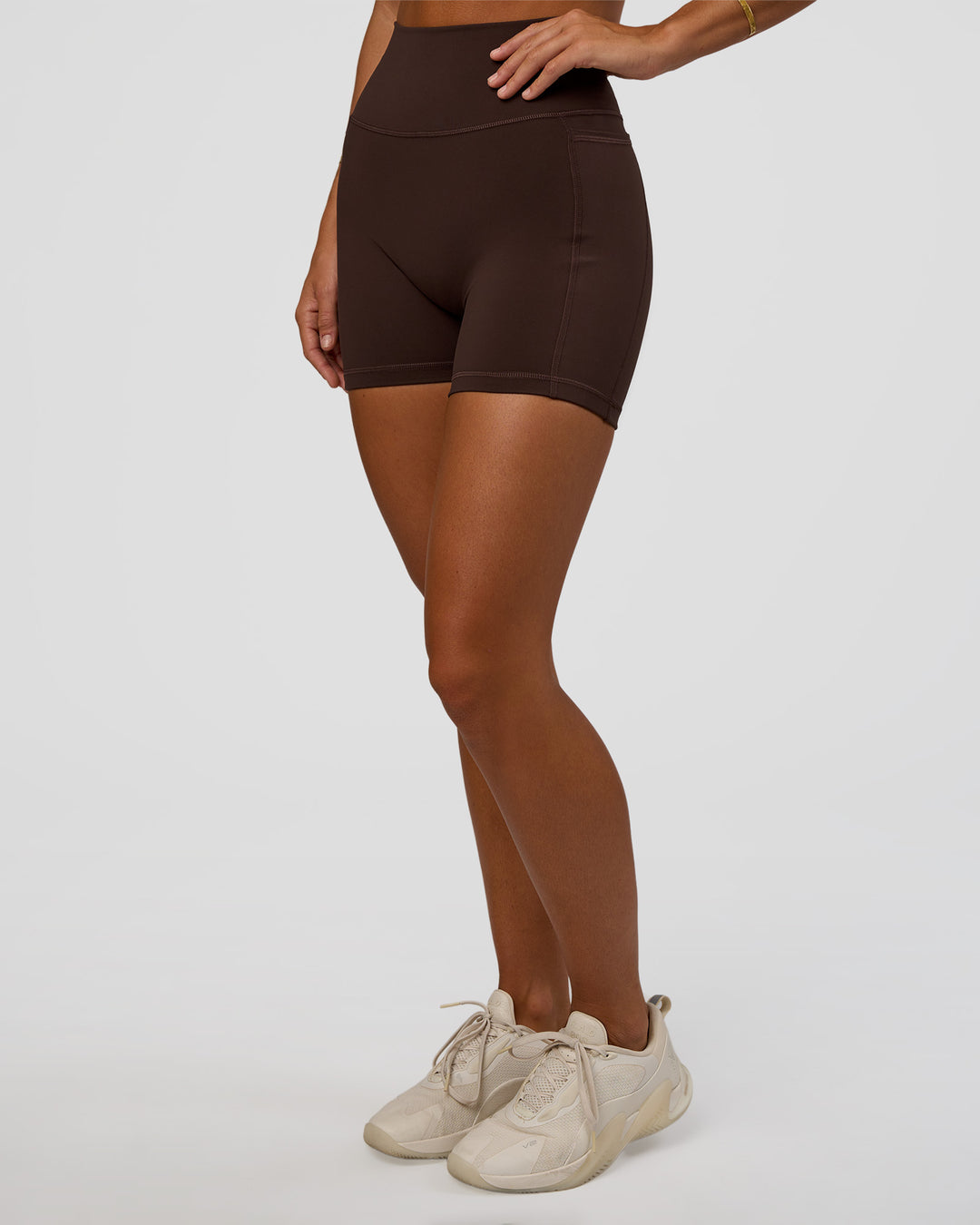Woman wearing Fusion V-Contour Ultra High-Rise 4” Short Pockets - Hot Chocolate | Model:Amity | Size:S - view 1