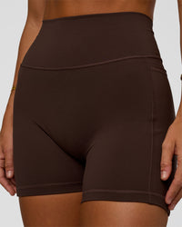 Woman wearing Fusion V-Contour Ultra High-Rise 4” Short Pockets - Hot Chocolate | Model:Amity | Size:S | Thumbnail Index: 4