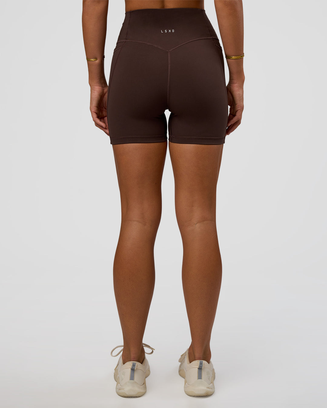 Woman wearing Fusion V-Contour Ultra High-Rise 4” Short Pockets - Hot Chocolate | Model:Amity | Size:S - view 2