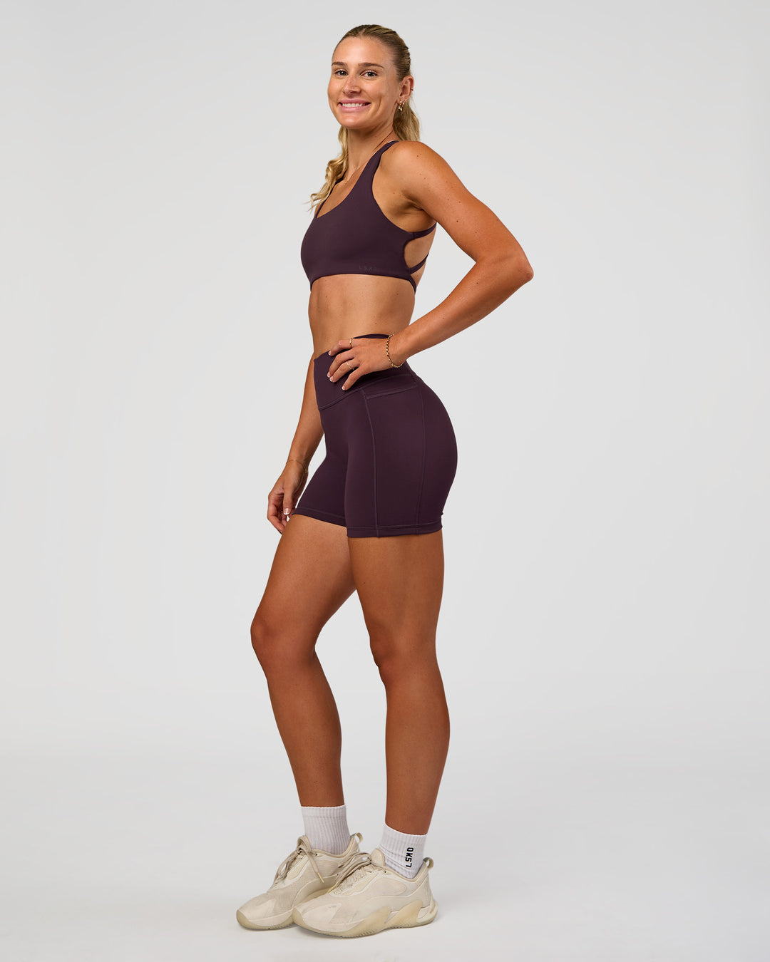 Woman wearing Fusion V-Contour Ultra High-Rise 4” Short Pockets - Midnight Plum | Model:Emelia | Size:S - view 6