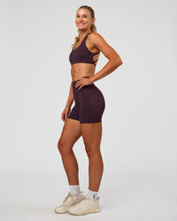 Woman wearing Fusion V-Contour Ultra High-Rise 4” Short Pockets - Midnight Plum | Model:Emelia | Size:S | Thumbnail Index: 5