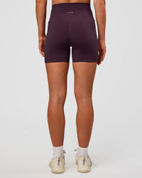 Woman wearing Fusion V-Contour Ultra High-Rise 4” Short Pockets - Midnight Plum | Model:Emelia | Size:S | Thumbnail Index: 4