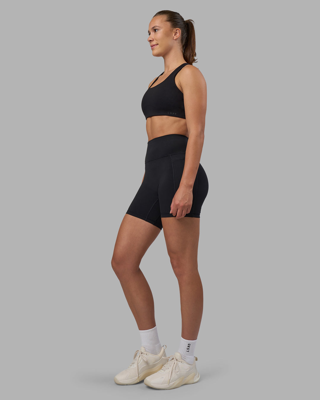 Woman wearing Fusion V-Contour Ultra High-Rise 6" Short Pockets - Black | Model:Charlize | Size:S - view 7