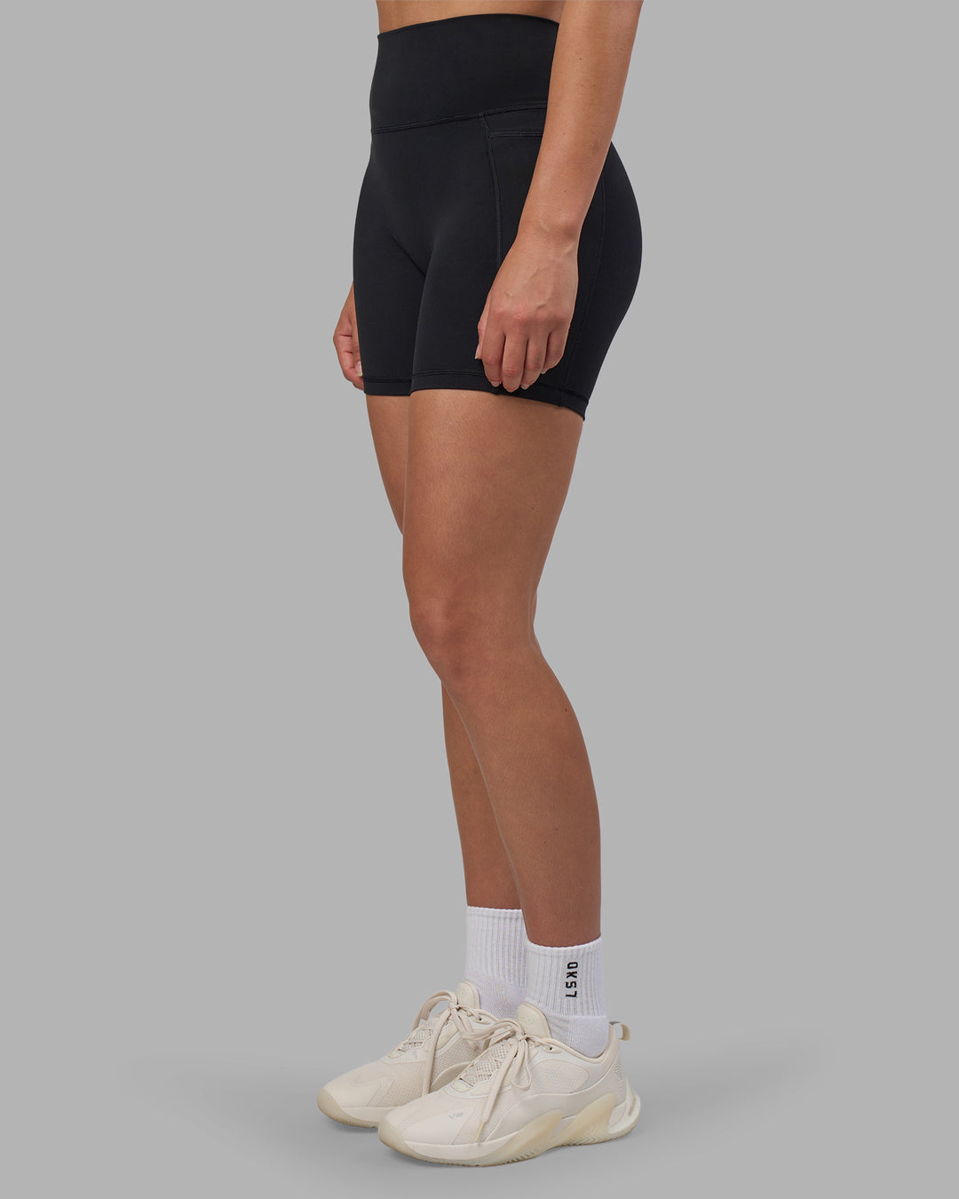 Woman wearing Fusion V-Contour Ultra High-Rise 6" Short Pockets - Black | Model:Charlize | Size:S - view 3