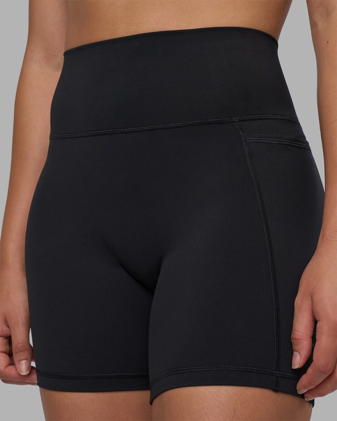 Woman wearing Fusion V-Contour Ultra High-Rise 6" Short Pockets - Black | Model:Charlize | Size:S - view 5