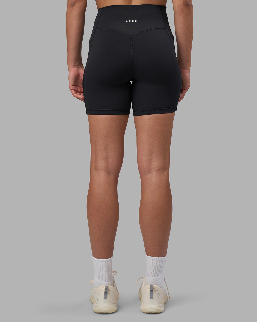 Woman wearing Fusion V-Contour Ultra High-Rise 6" Short Pockets - Black | Model:Charlize | Size:S - view 11