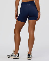Woman wearing Fusion V-Contour Ultra High-Rise 6" Short Pockets - Future Navy 
| Model:Amity | Size:S | Thumbnail Index: 4