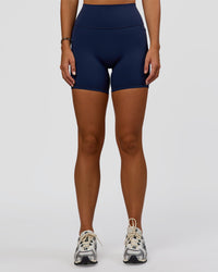 Woman wearing Fusion V-Contour Ultra High-Rise 6" Short Pockets - Future Navy 
| Model:Amity | Size:S | Thumbnail Index: 5