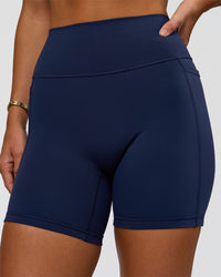 Woman wearing Fusion V-Contour Ultra High-Rise 6" Short Pockets - Future Navy 
| Model:Amity | Size:S | Thumbnail Index: 6