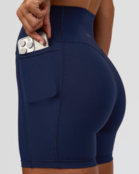 Woman wearing Fusion V-Contour Ultra High-Rise 6" Short Pockets - Future Navy 
| Model:Amity | Size:S | Thumbnail Index: 3