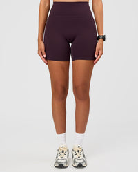 Woman wearing Fusion V-Contour Ultra High-Rise 6" Short Pockets - Midnight Plum | Model:Rhiley | Size:S | Thumbnail Index: 3