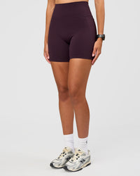 Woman wearing Fusion V-Contour Ultra High-Rise 6" Short Pockets - Midnight Plum | Model:Rhiley | Size:S | Thumbnail Index: 1