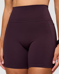 Woman wearing Fusion V-Contour Ultra High-Rise 6" Short Pockets - Midnight Plum | Model:Rhiley | Size:S | Thumbnail Index: 6