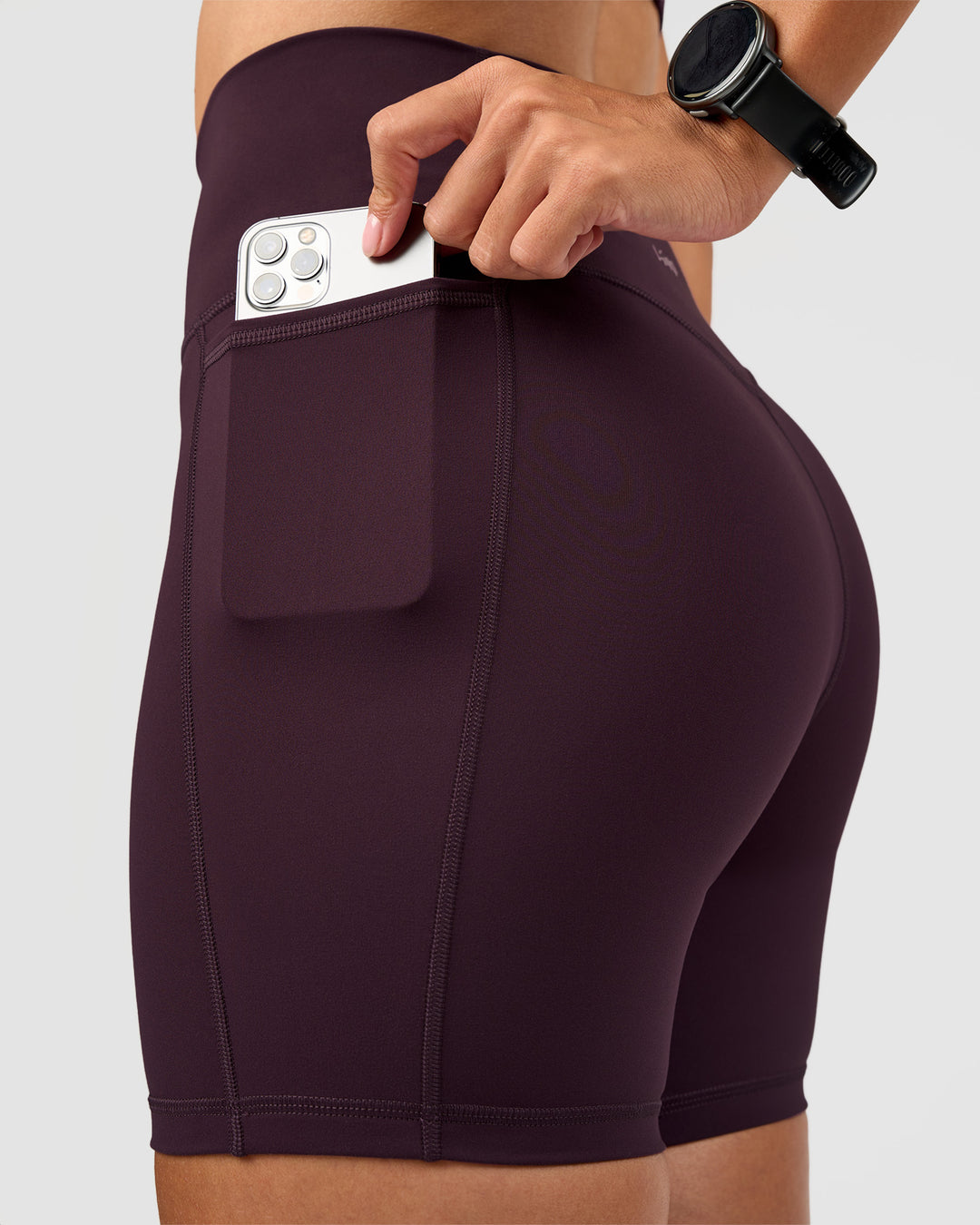 Woman wearing Fusion V-Contour Ultra High-Rise 6" Short Pockets - Midnight Plum | Model:Rhiley | Size:S - view 5