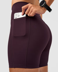 Woman wearing Fusion V-Contour Ultra High-Rise 6" Short Pockets - Midnight Plum | Model:Rhiley | Size:S | Thumbnail Index: 4