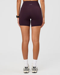 Woman wearing Fusion V-Contour Ultra High-Rise 6" Short Pockets - Midnight Plum | Model:Rhiley | Size:S | Thumbnail Index: 5