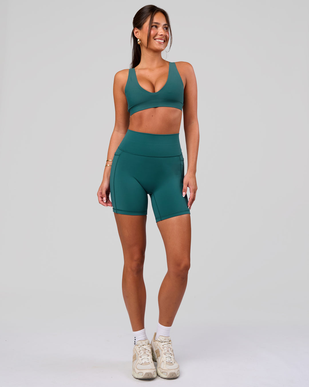Woman wearing Fusion V-Contour Ultra High-Rise 6" Short Pockets - Transformative Teal | Model:Bianca | Size:S - view 3